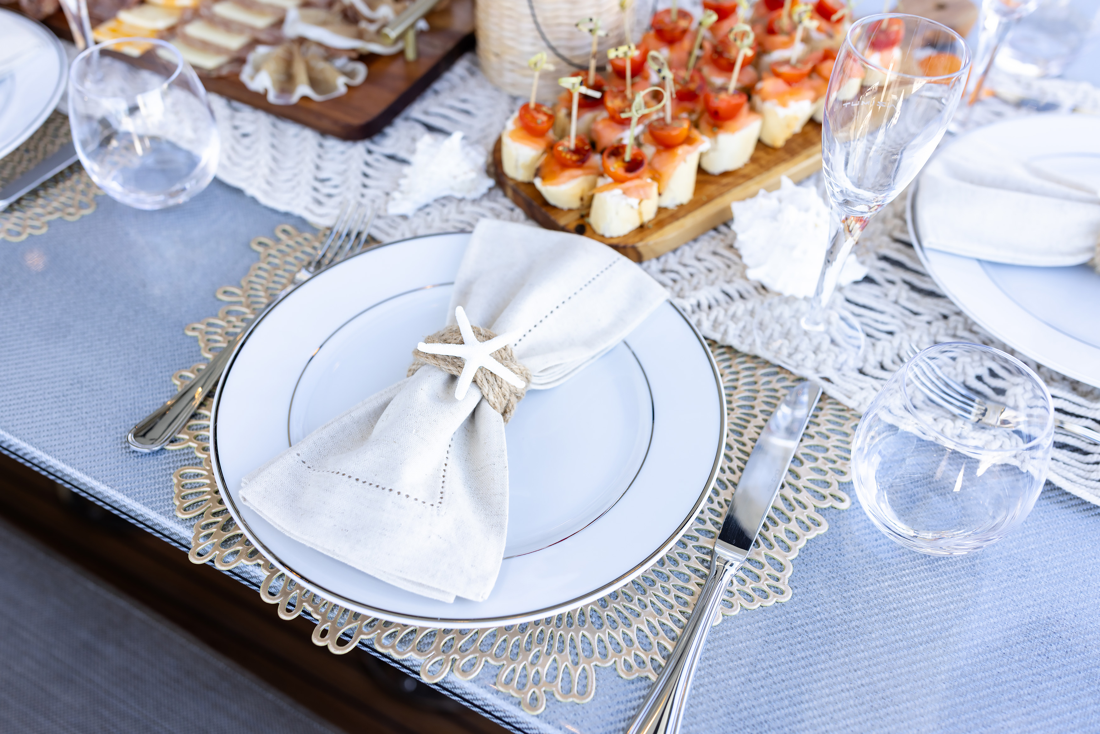 Place setting detail with geometric placemats and stemware