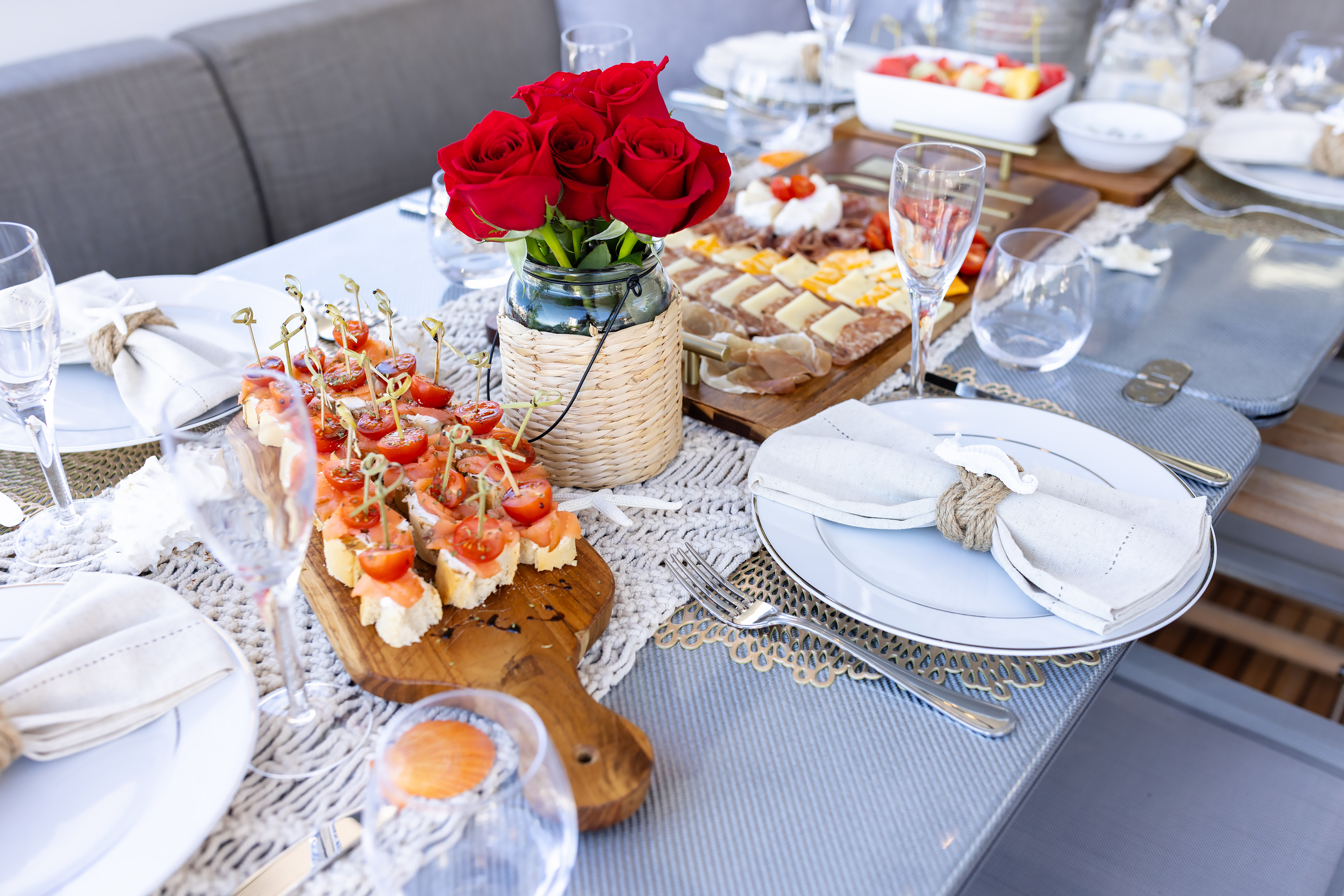 Fresh red roses and gourmet charcuterie board