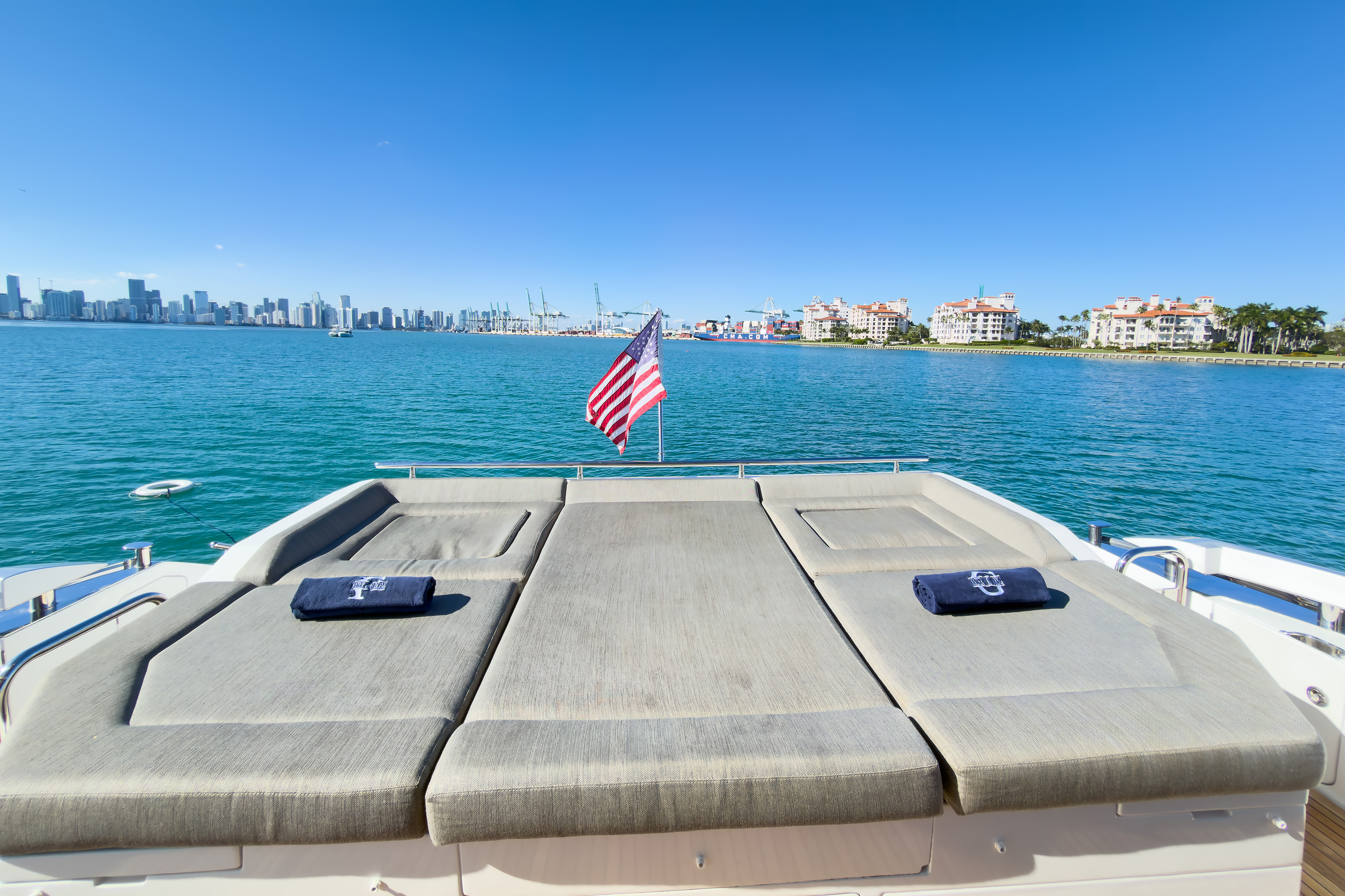 Flybridge sunbeds with navy towels and American flag
