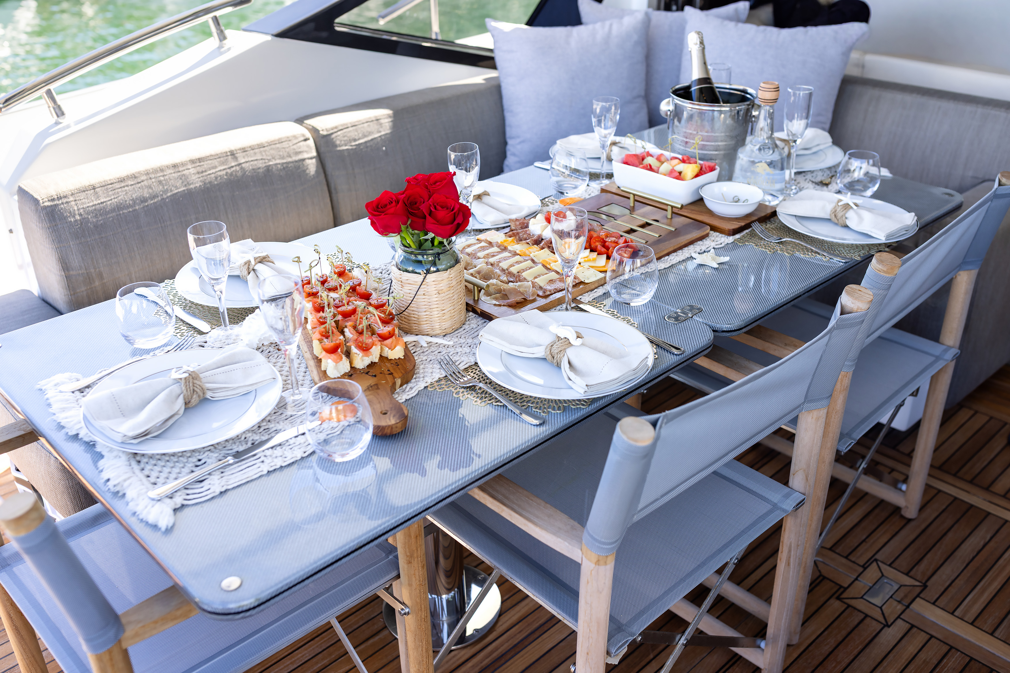Outdoor deck dining with formal table setting and ocean views