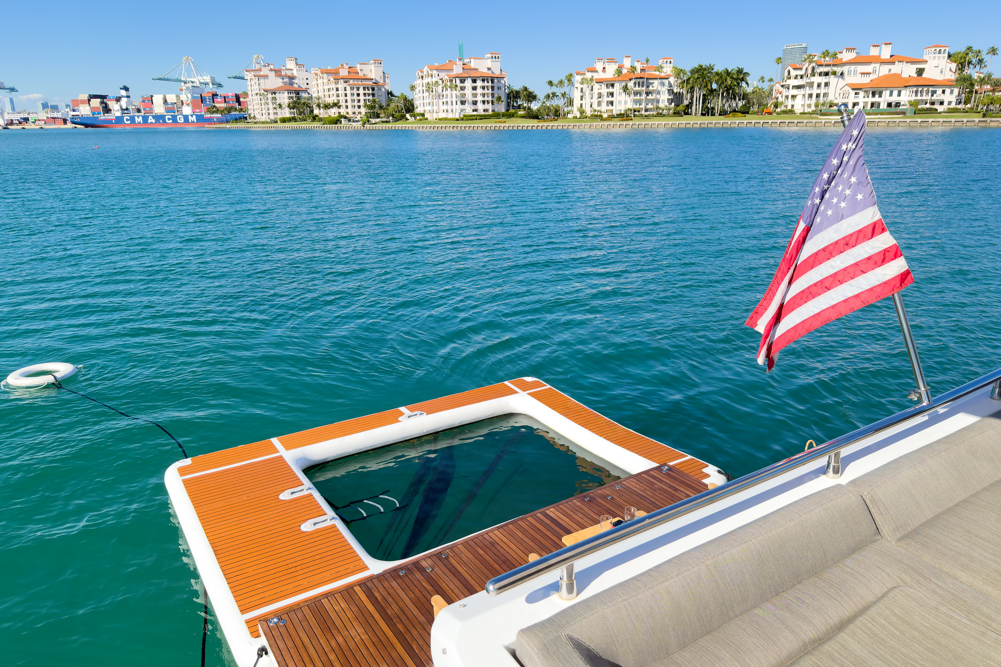 Swim platform with cushioned seating and coastal views